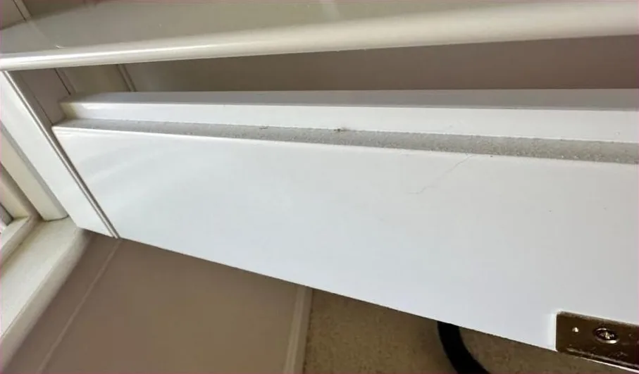 Dusty baseboard heater before cleaning