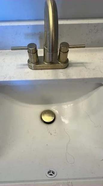 Bathroom sink with residue before cleaning